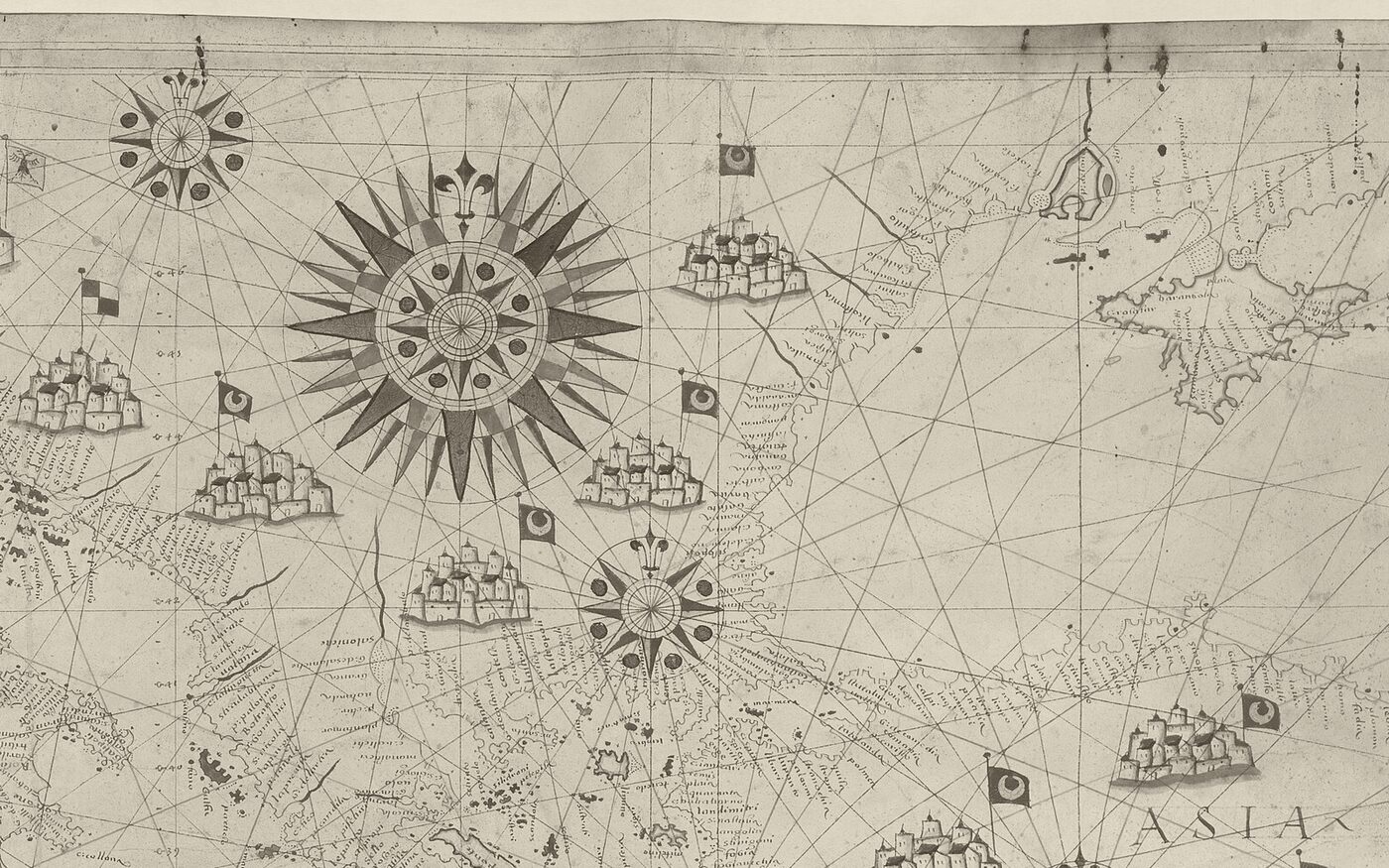 A close detail of a hand-drawn 1639 sea chart &mdash; an ornate compass rose with rhumb lines radiating across the parchment