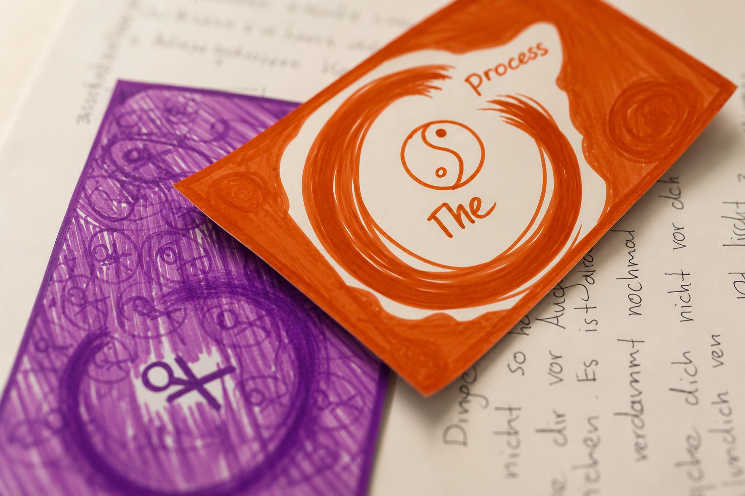 A journal page with an orange yin-yang mandala on pencilled purple — The Process